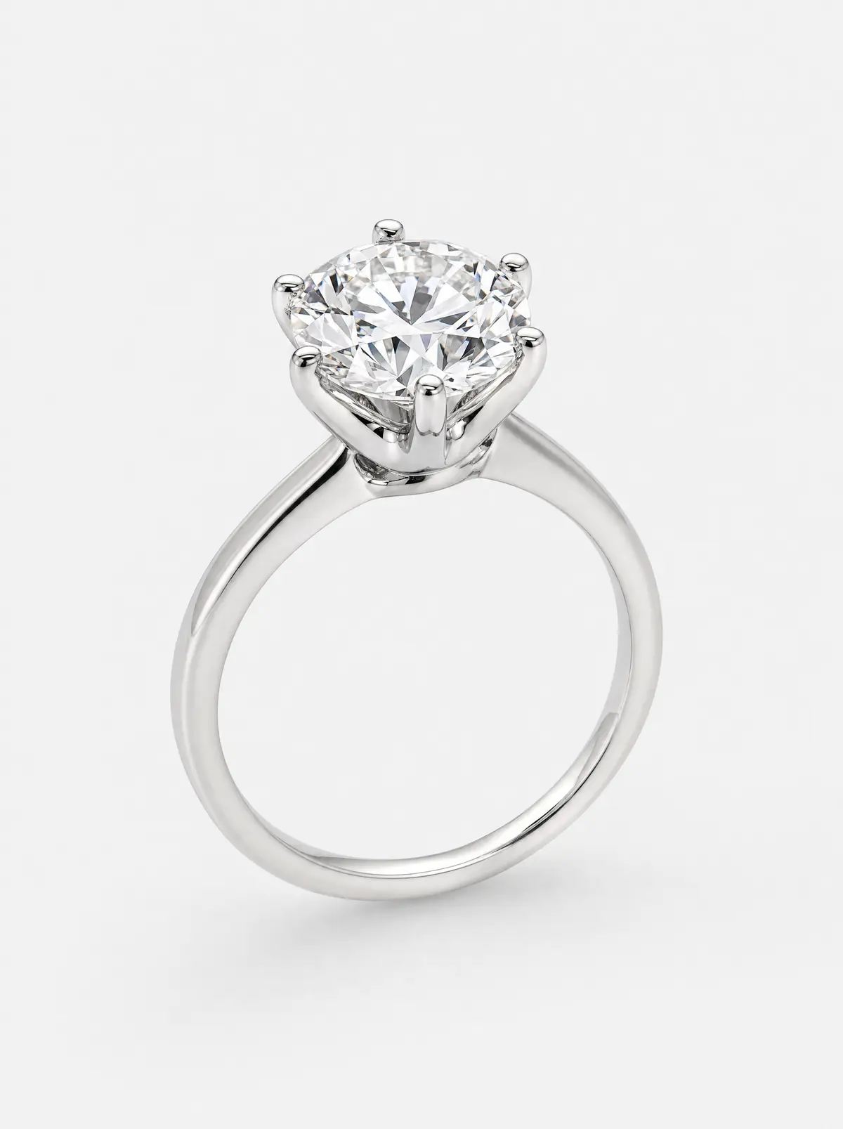 A platinum round diamond solitaire engagement ring on light grey (illustrative, generated)