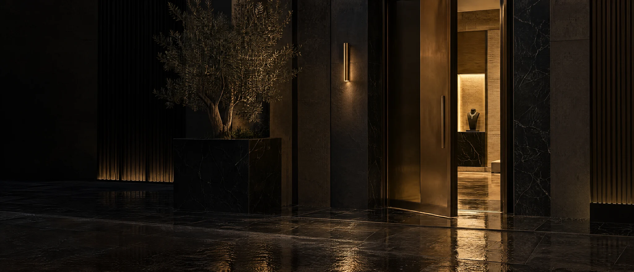The private entrance of a modern jewelry house at night: a bronze door ajar, warm light on wet black stone, a necklace glowing inside (illustrative, generated)